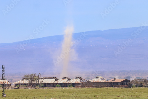 dust tornado over destroyed buildings in Africa