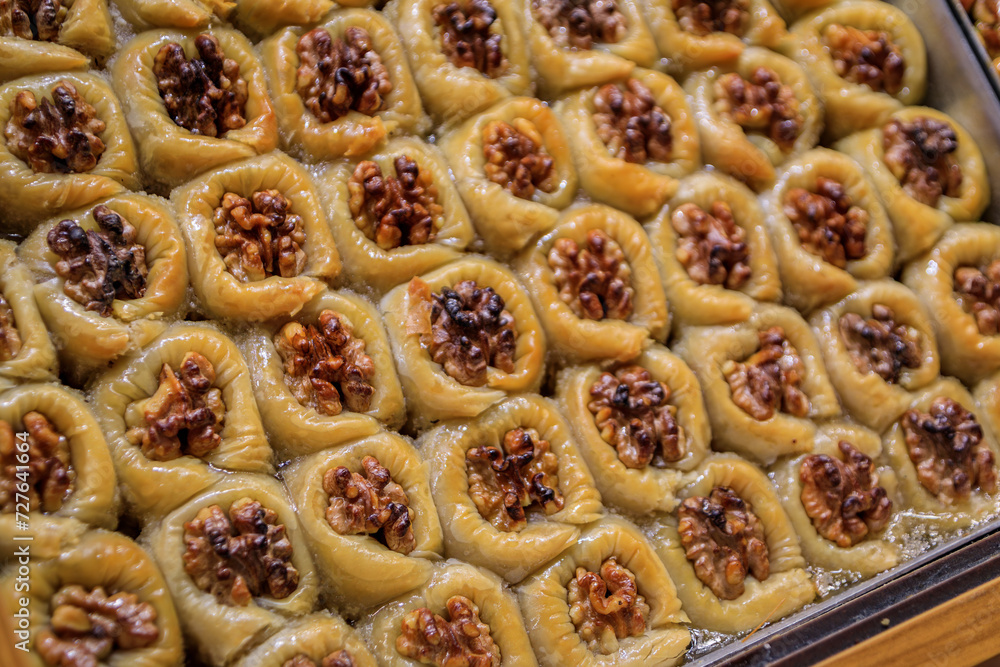 Traditional Turkish dessert, walnut birds nest baklava or bulbul yuvasi whole nuts in fresh phyllo dough at a local pastry shop in Istanbul, Turkey