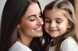 A young mother with dark hair holds in her arms a little girl with her eyes closed, a woman looks at the child, they smile, blurred background, closeup