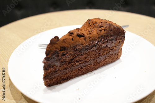 A Dark chocolate cake at white plate