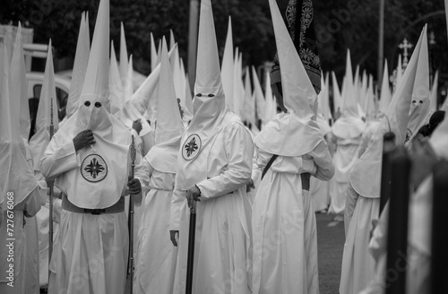 фотографія the penitents gathered ready to undertake the Easter procession