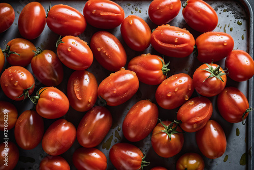 Pile of plum tomatoes on gray metal surface, san marzano tomatoes washed to be canned during the height of the summer tomato season. photo