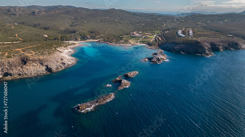 Fototapeta Naklejka Na Ścianę i Meble -  Aerial view of Cala Sapone, S. Antioco bay in Sardinia. Crystal clear sea, moored boat and white sand.