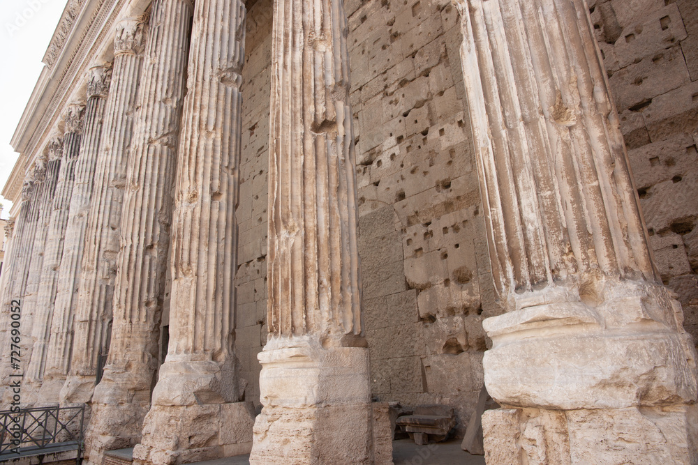 Ancient weathered stone pillars of Hadrian's Temple colonnade