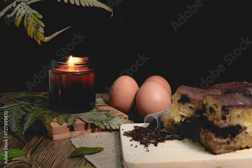 Chocolate sweet Indonesian thick-folded crepe or Martabak manis/Terang Bulan food photography with candles and tropical leaves