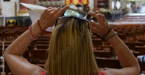 A woman is taking a picture in a church