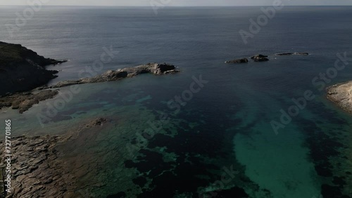 Aerial view of Cala Sapone, S. Antioco bay in Sardinia. Crystal clear sea, moored boat and white sand.