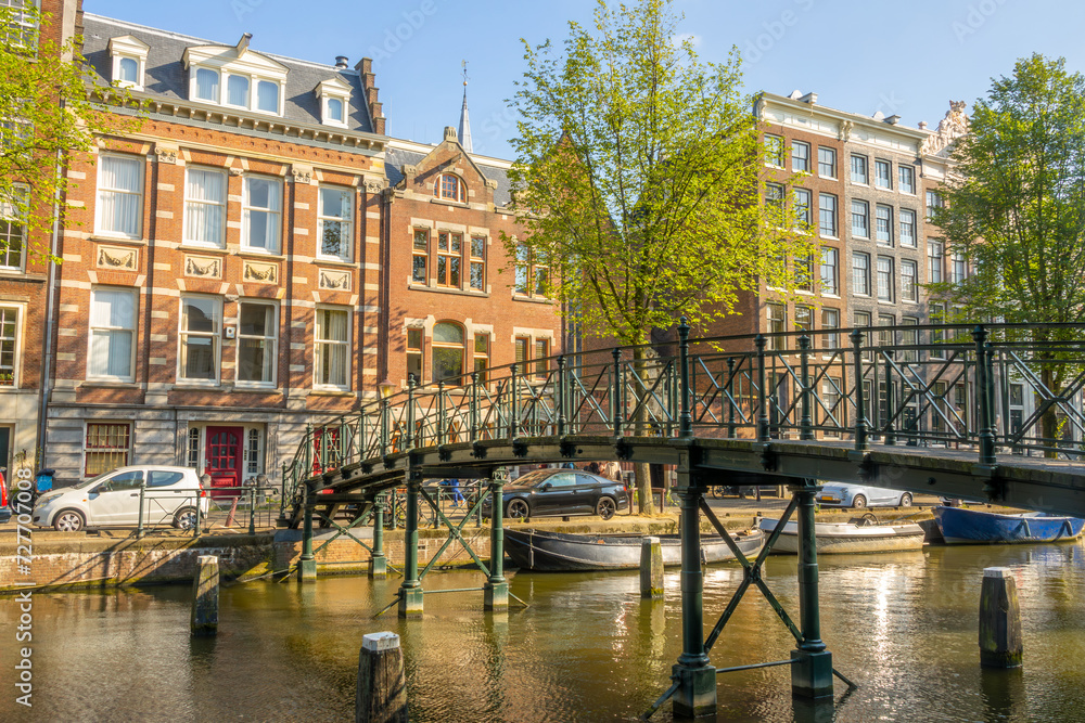 Fototapeta premium Old Footbridge Over a Canal in Amsterdam