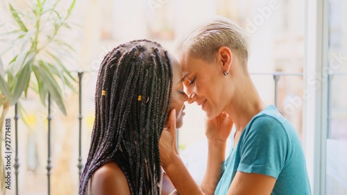 Lesbian couple about to kiss passionately at home