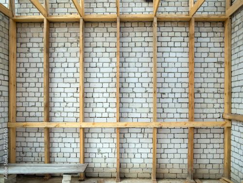 Installation of wooden sheathing inside a brick room
