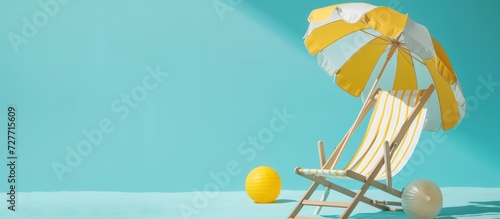 Summer holiday concept beach chair with yellow umbrella and Ball on blue background. Generated AI photo