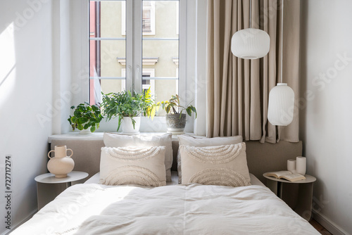 Scandinavian interior in bedroom with comfort double bed, blanket and pillows © brizmaker