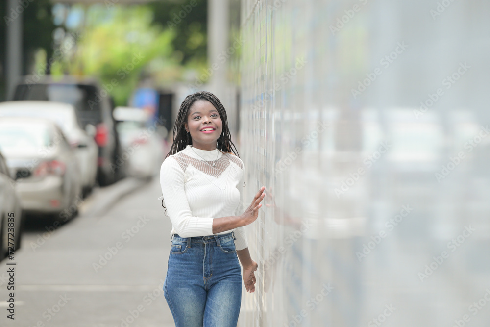 Fototapeta premium A young woman with his hairstyle and the atmosphere of living in the community.