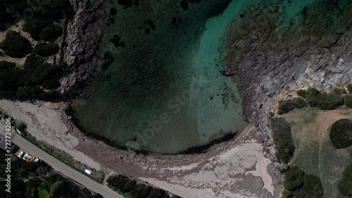 Aerial view of Cala Sapone, S. Antioco bay in Sardinia. Crystal clear sea, moored boat and white sand.