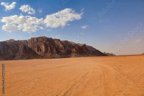 desert valley with orange sand and rocky mountains