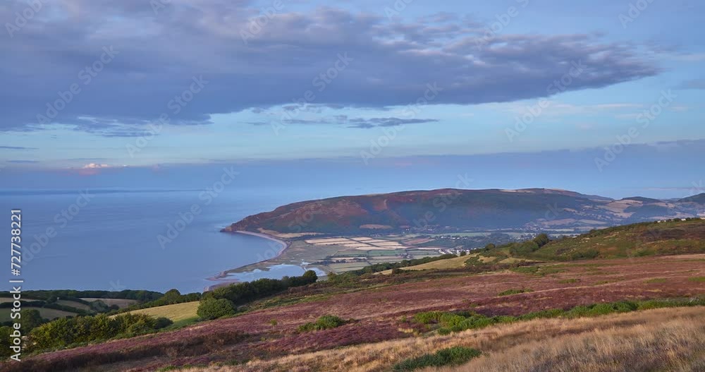Time lapse sequence of farming land and coast line with the town of Porlock in the background, Porlock, Wales, United Kingdom