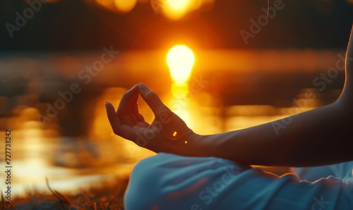 close-up of a serene outdoor yoga session at sunrise, focused on the harmony of hands in a mudra against a soft, glowing background