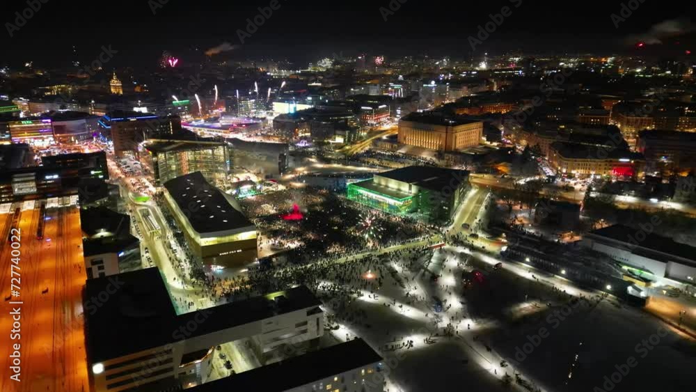 A night view of the city of Helsinki on New Year's Eve, with a dazzling display of colorful lights and vibrant fireworks. A night view of the city of Helsinki on New Year's Eve, with a dazzling display of colorful lights and vibrant fireworks.