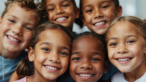 Group of joyful diverse children close-up, smiling faces, multiethnic friendship, kids together, cheerful young group, childhood happiness, portrait of happy boys and girls, playful youth. © Tom