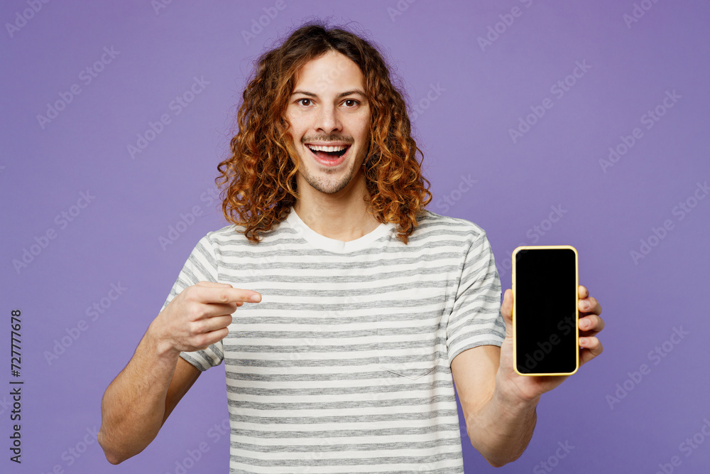 Young man wear grey striped t-shirt casual clothes hold use point index finger on mobile cell phone with blank screen workspace area isolated on plain pastel light purple background Lifestyle concept Young man wear grey striped t-shirt casual clothes hold use point index finger on mobile cell phone with blank screen workspace area isolated on plain pastel light purple background Lifestyle concept