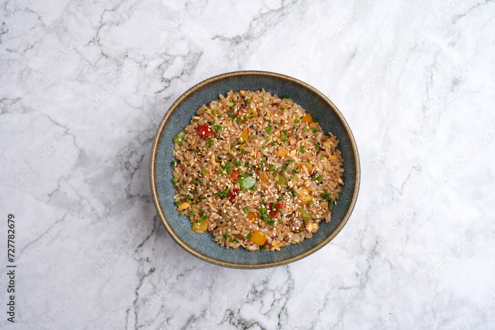 Fried rice with vegetables. Prepared and served in a wok Fried rice with vegetables. Prepared and served in a wok