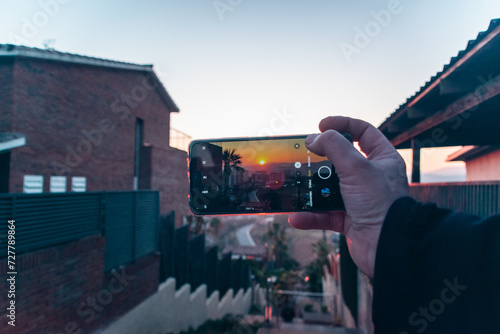 sunset between buildings from the mobile phone