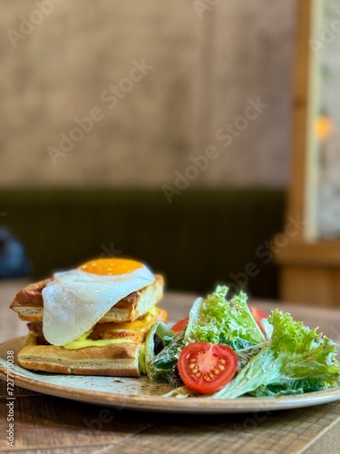 waffles with fried egg and salad