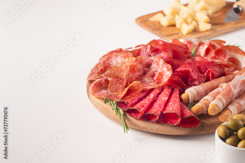 Charcuterie board. Antipasti appetizers of meat platter with salami, prosciutto crudo or jamon and olives.