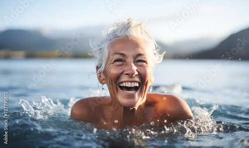 Fearless Senior Woman Embracing the Winter Chill as She Swims in Refreshing Cold Water to Boost Her Health and Wellness © Bartek