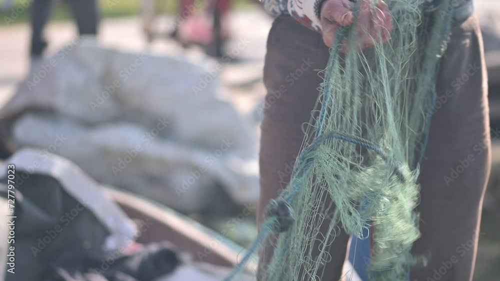 Fisherman Preparing Fishing Nets for Hunting Fisherman Preparing Fishing Nets for Hunting