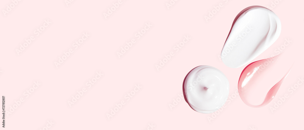 Set of white and pink cream strokes on a pink background. empty space Set of white and pink cream strokes on a pink background. empty space