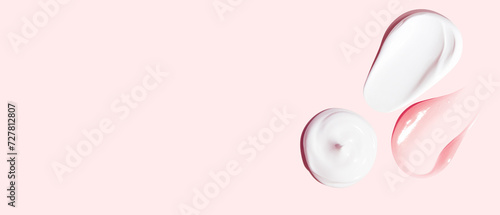 Set of white and pink cream strokes on a pink background. empty space
