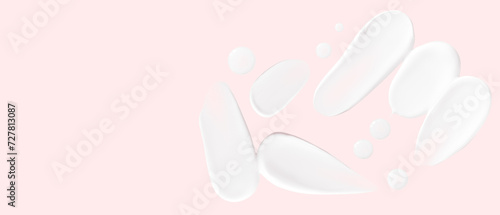 Set of smears of cream and drops of transparent gel on a pink background. Empty space
