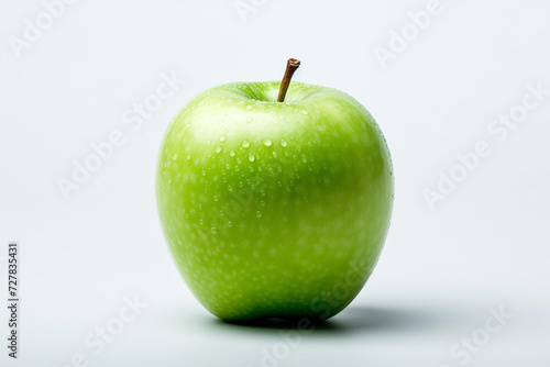 A fresh, green apple with water droplets against a white background.
