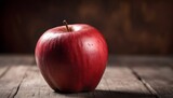 Close-up of a red apple on wooden table