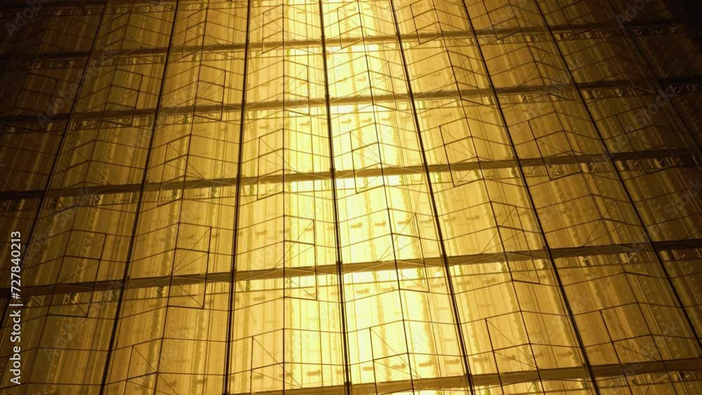 Greenhouse in the winter season. The conservatory building is at night. A hothouse luminous greenhouse for growing vegetables in Arctic conditions. Winter glasshouse gardening. Luminous glass building Greenhouse in the winter season. The conservatory building is at night. A hothouse luminous greenhouse for growing vegetables in Arctic conditions. Winter glasshouse gardening. Luminous glass building