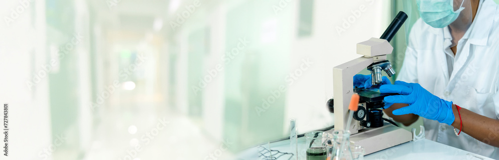 Banner Scientist man look Microscope research in science laboratory. Banner Asian scientist use microbiology microscope in laboratory equipment chemistry lab. Biochemistry experiment with copy space Banner Scientist man look Microscope research in science laboratory. Banner Asian scientist use microbiology microscope in laboratory equipment chemistry lab. Biochemistry experiment with copy space
