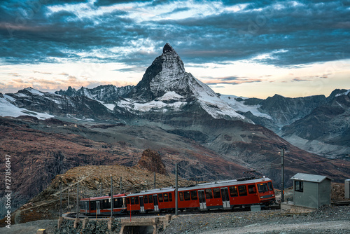 Electric train running on railway through Matterhorn mountain in Gornergrat station photo
