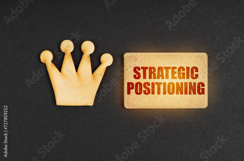 On a black background there is a wooden crown of the leader and a sign with the inscription - Strategic Positioning