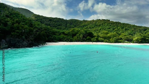 Aerial view of gorgeous tropical beach and lagoon with lush mountains