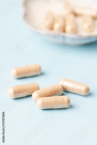Coenzyme Q10 capsules. Dietary supplements. Bright paper background. Close up. 