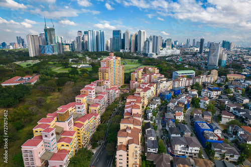 Taguig, Metro Manila, Philippines -  Aerial of upscale houses and condominiums in Mckinley Hill, American Cemetery and BGC in the distance. photo