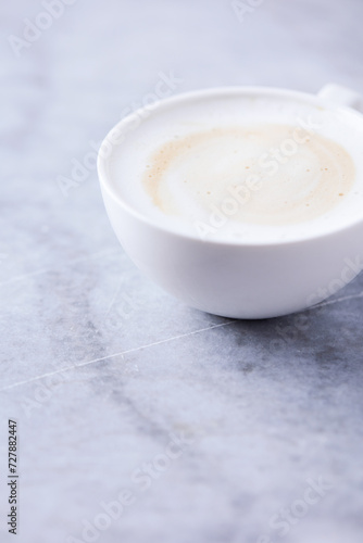 Cup of Coffee on bright stone background. Close up. 