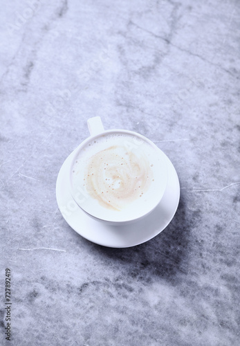 Cup of Coffee on bright stone background. Close up. 