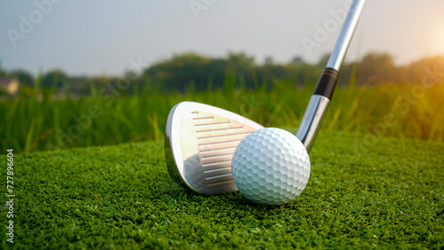 Golf club and ball in green grass. Golf balls on the golf course with golf clubs ready for golf in the first short.