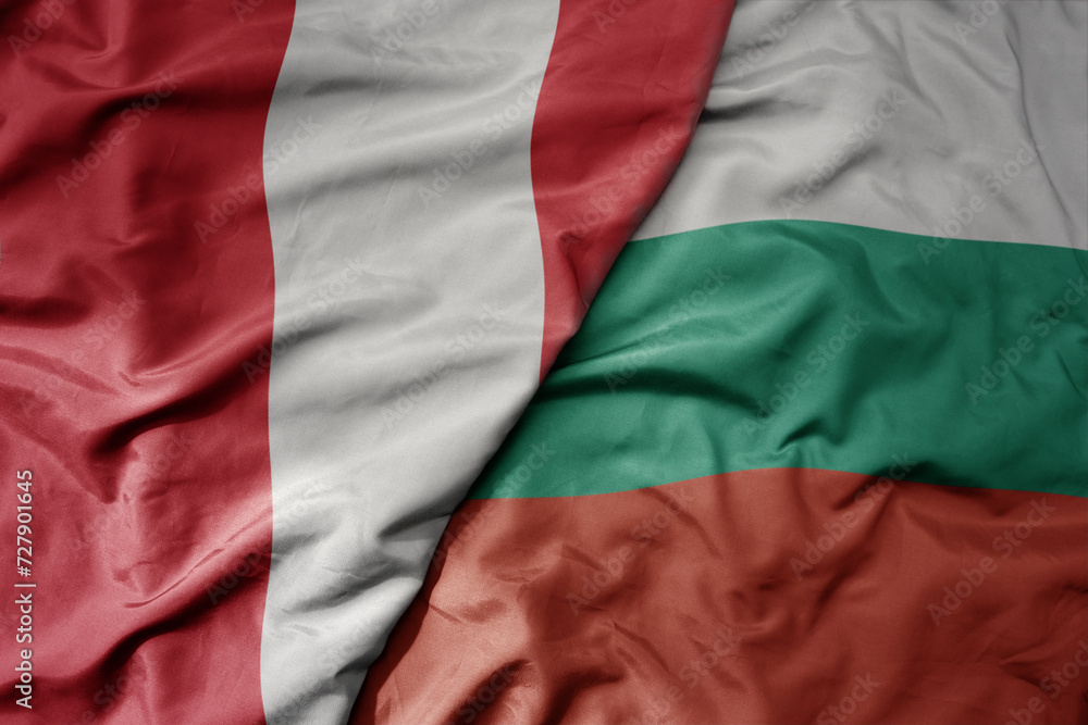 big waving national colorful flag of bulgaria and national flag of peru .