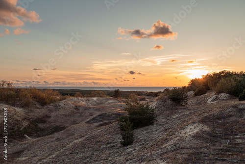 Sand dune, sea, horizon line and clouds at sunset in the evening, Efa Dune