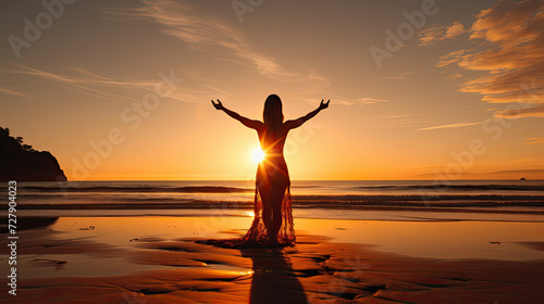Silhouette of a female experiencing freedom and serenity on the beach during a beautiful sunset promoting wellness and travel