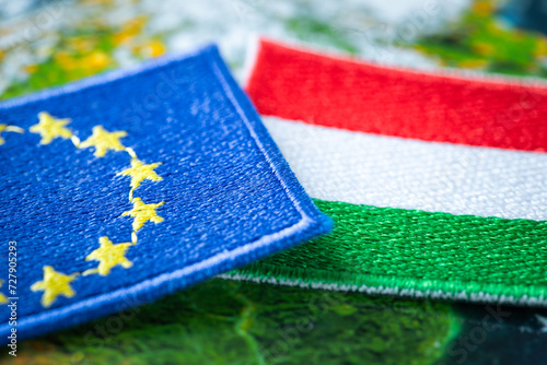 Hungary and european union patches overlapping on europe map, concept of cooperation between union countries, flags of hungary and european union