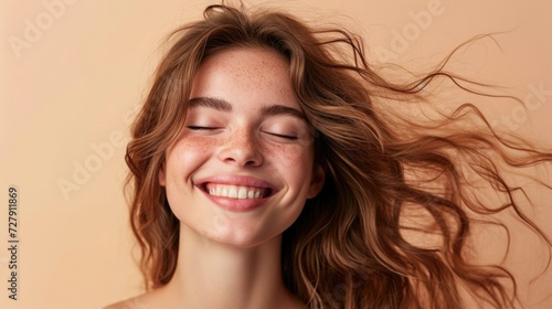 Radiant Woman with Luscious Hair Against Beige Background
